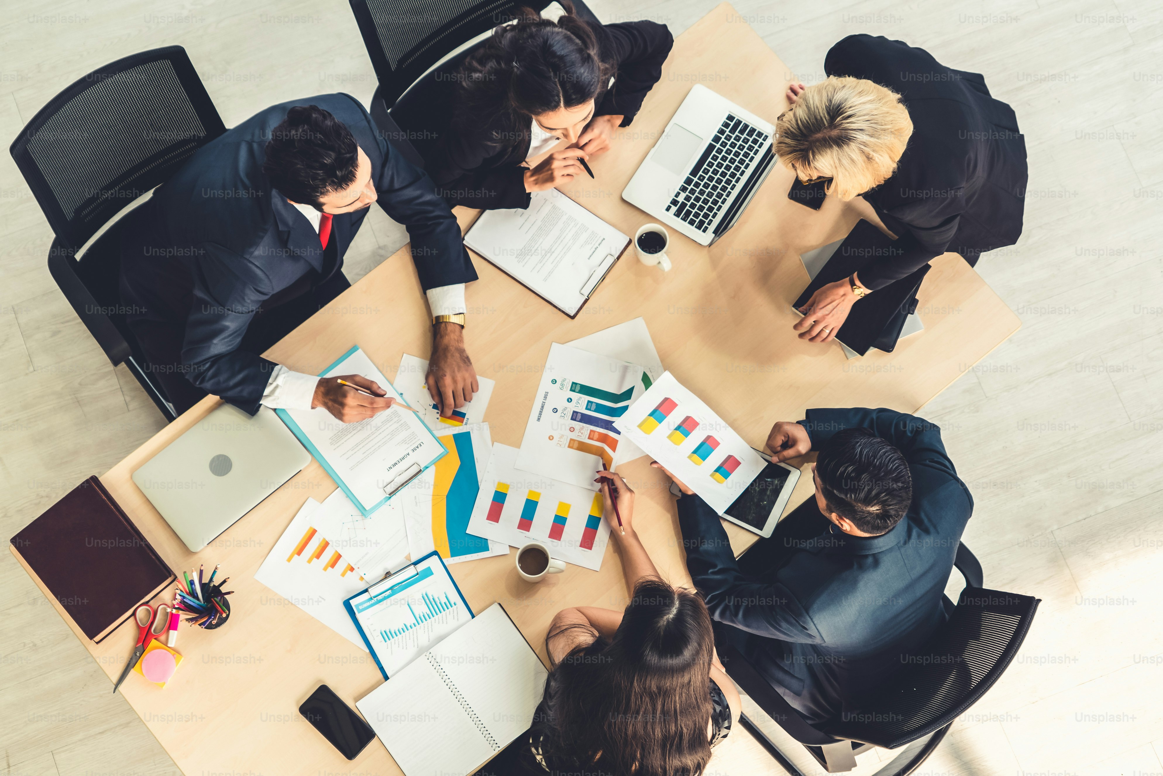 Business people group meeting shot from top view in office . Profession businesswomen, businessmen and office workers working in team conference with project planning document on meeting table .