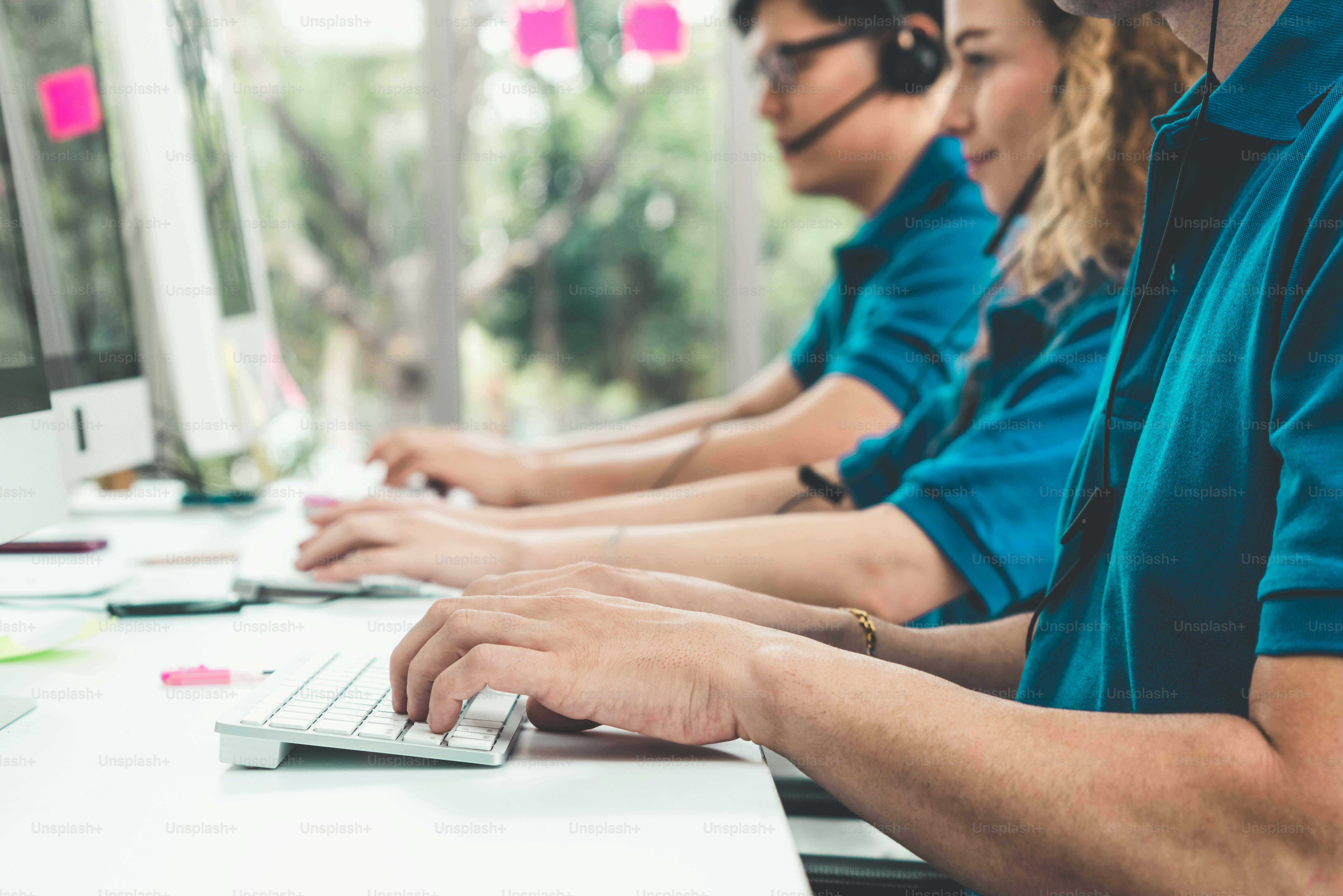 Close up shot of business people hand typing and working on desktop computer on the office desk. Business communication and workplace concept.