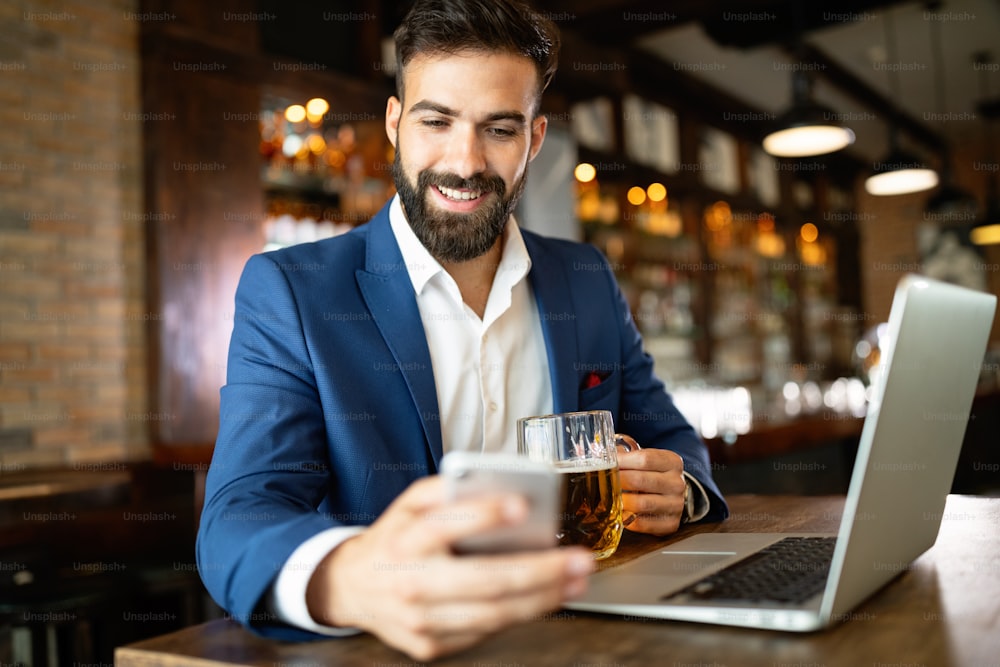 Handsome young business man, blogger or remote working with laptop in restaurant