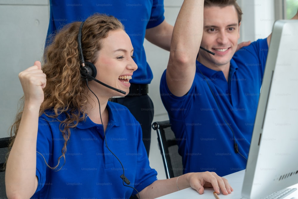 Business people wearing headset celebrate working in office . Call center, telemarketing, customer support agent provide service on telephone video conference call.