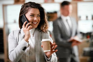 Beautifull businesswoman talking to the phone in office.