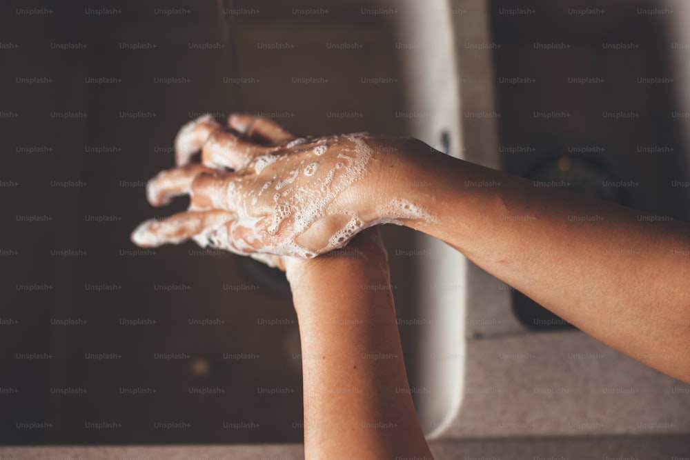 Caucasian person washing hands with soap during the quarantine