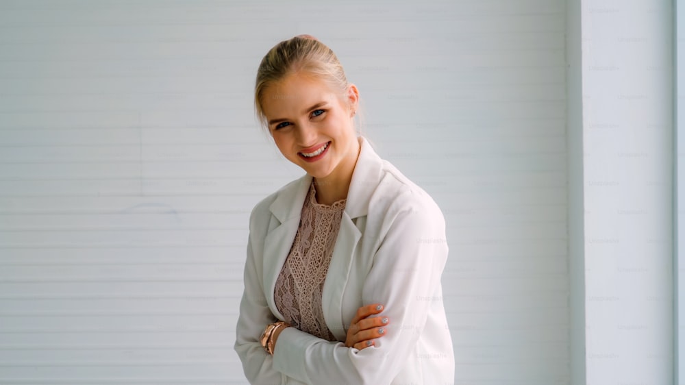 Attractive young woman profile portrait in office . Confident business person wearing formal suit working in corporate business.