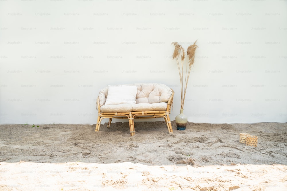 Boho eco styled beach essentials on sand by sea. Romantic picnic for couple on the beach.