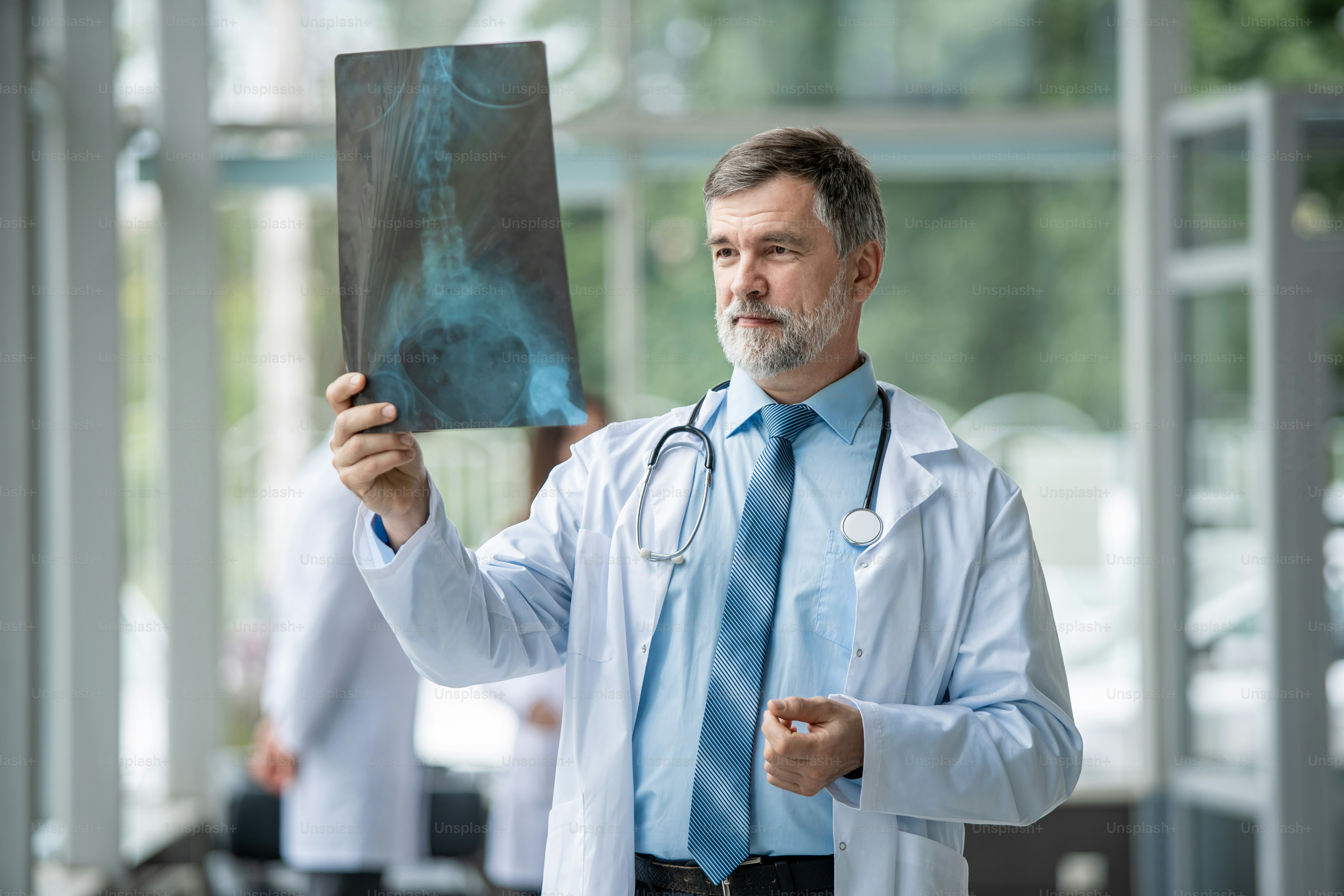 Mature Doctor looking at an x-ray results in a hospital