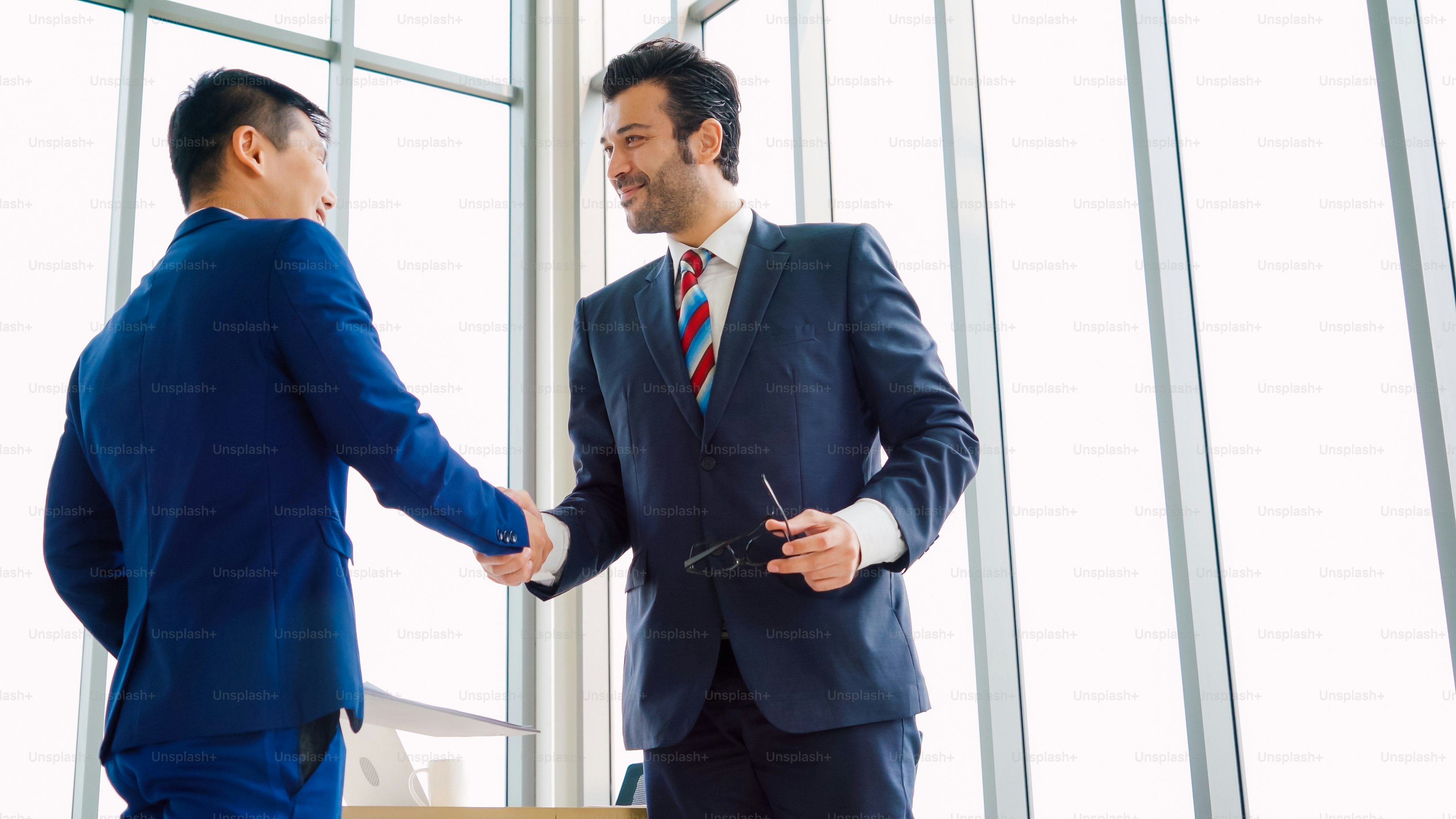 Business people handshake in corporate office showing professional ...