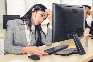 Business people wearing headset feel unhappy working in office . Failure negative sadness emotion concept of call center, telemarketing and customer support crisis in financial economy down fall .