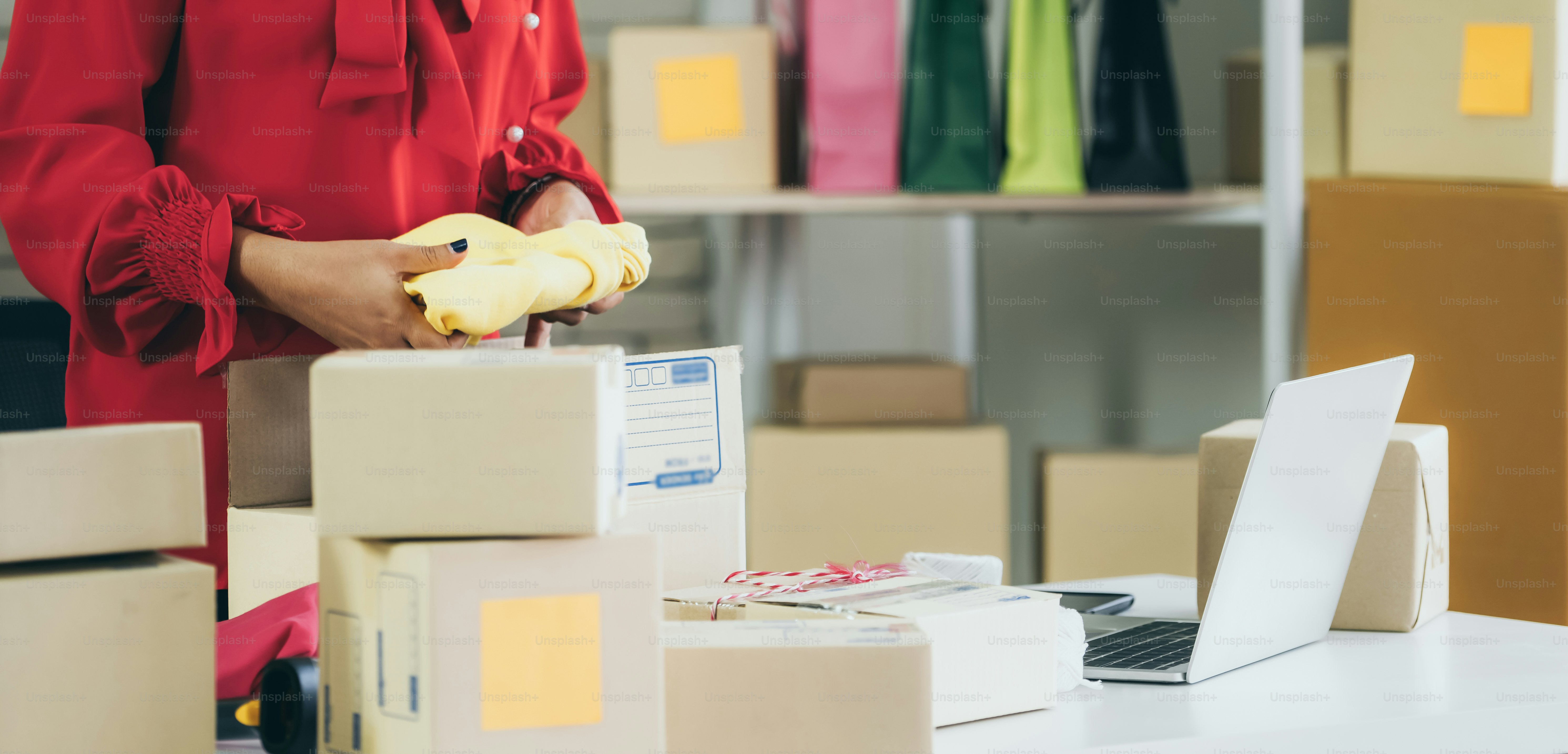 Online seller works at home office and packs shipping delivery box to customer. Small business owner or entrepreneur doing e-commerce business on the internet.