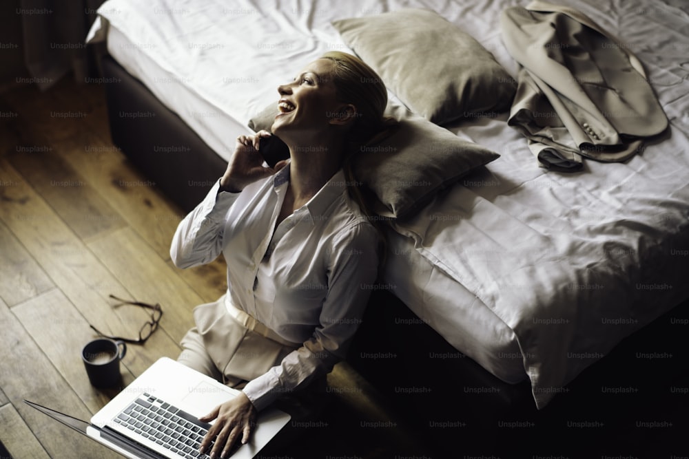 Businesswoman working from a hotel room. Beautiful young woman working on lap top