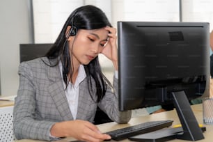 Las personas de negocios que usan auriculares se sienten infelices trabajando en la oficina. Fracaso tristeza negativa emoción concepto de centro de llamadas, telemarketing y crisis de atención al cliente en la economía financiera caída.
