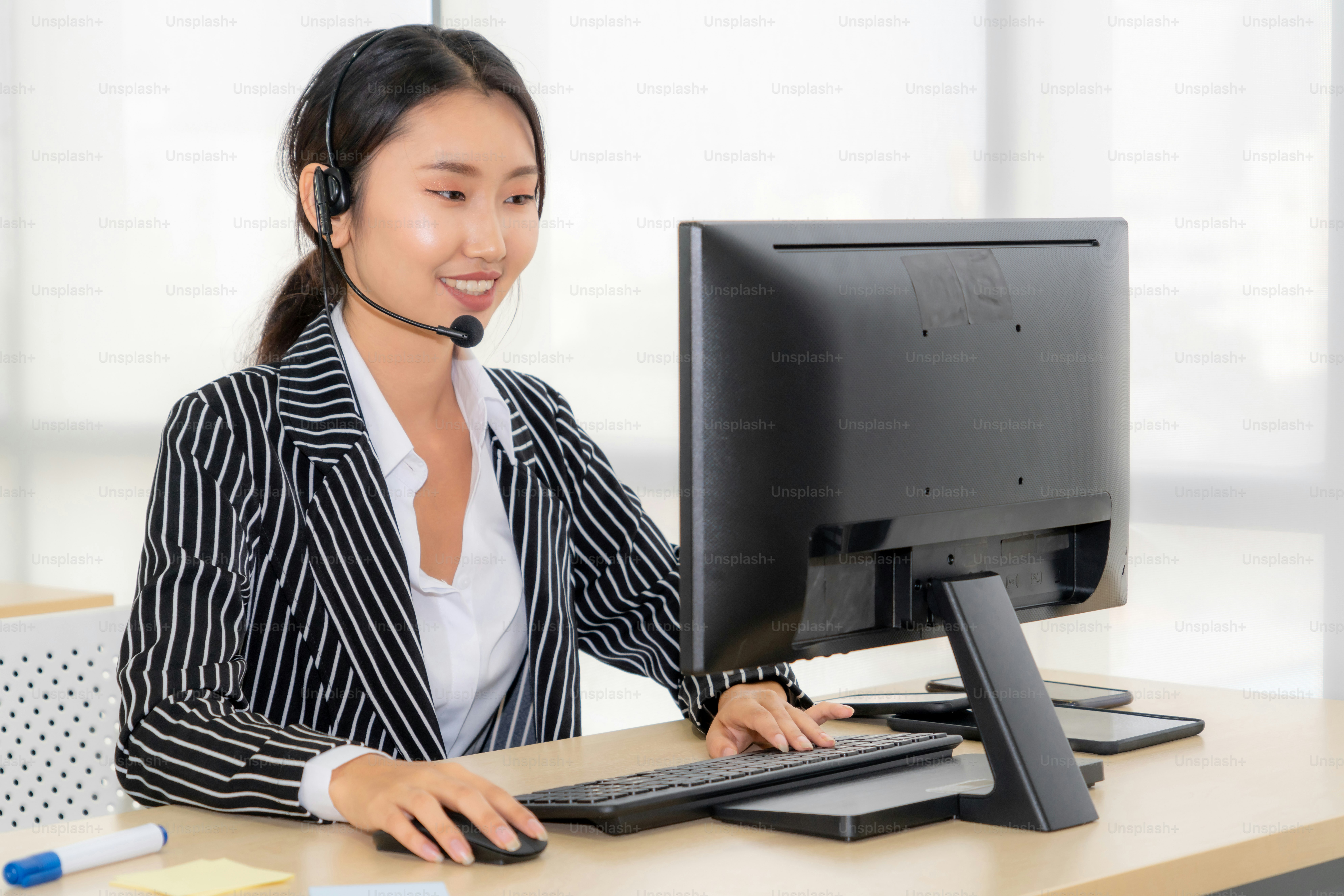 Business people wearing headset working in office to support remote customer or colleague. Call center, telemarketing, customer support agent provide service on telephone video conference call.