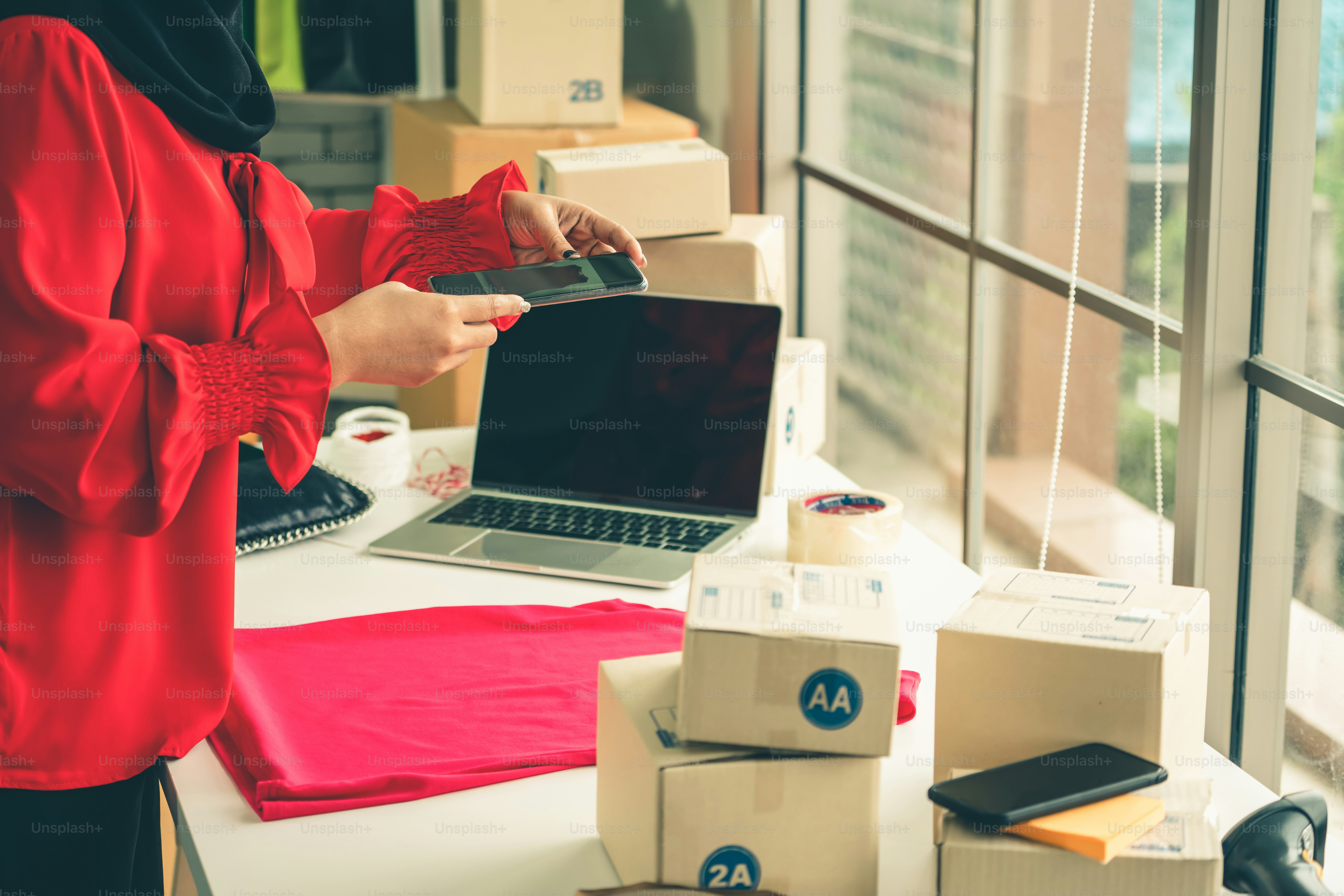 Online seller works at home office and packs shipping delivery box to customer. Small business owner or entrepreneur doing e-commerce business on the internet.