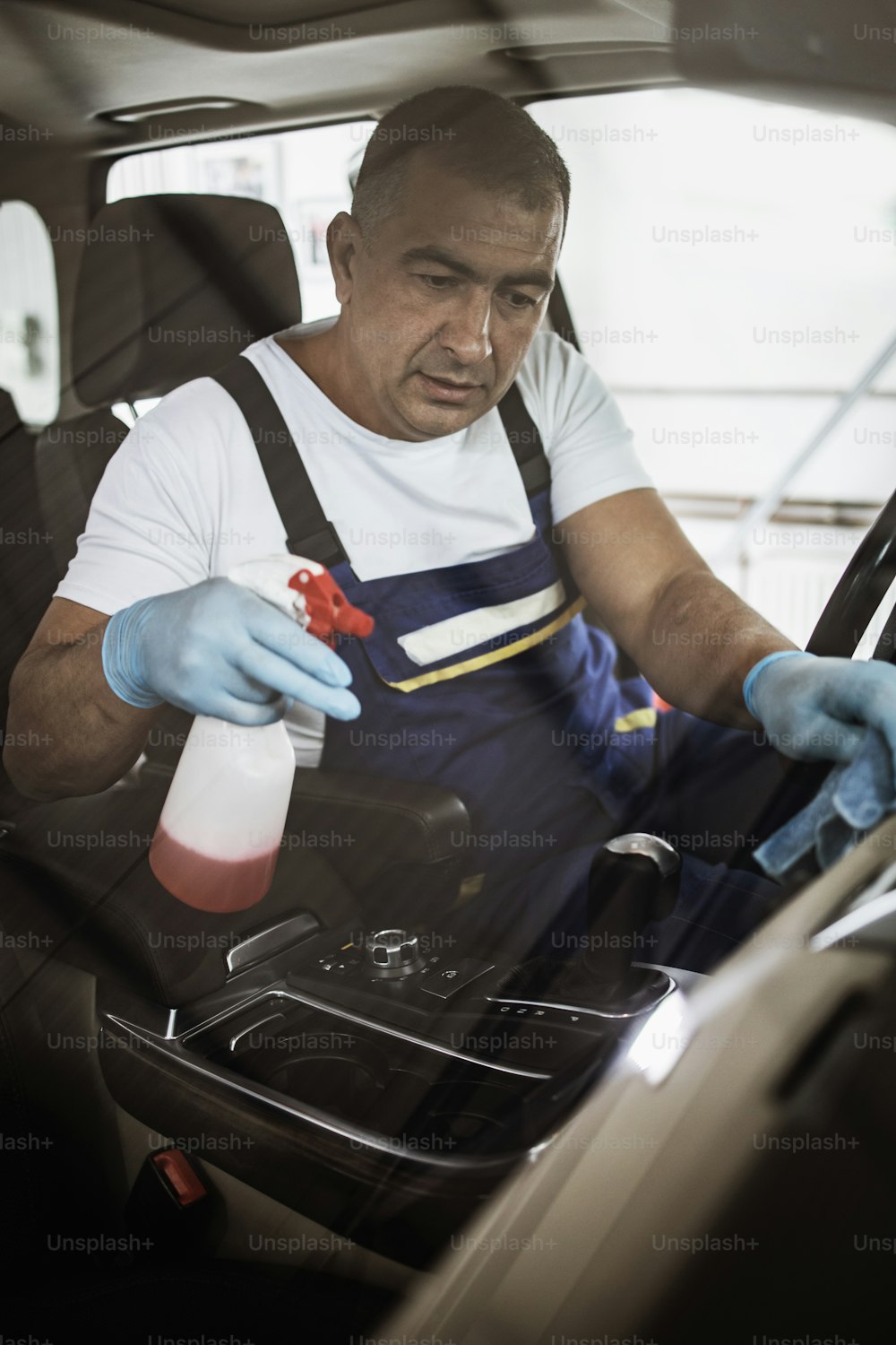 Trabalhador de serviço de lavagem de carros limpeza úmida caro e luxuoso interior do veículo e assentos