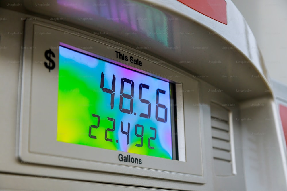 ガソ��リンポンプの燃料費が上昇し、デジタル表示でドルをカウンター
