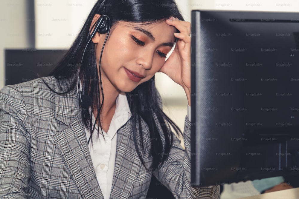 Business people wearing headset feel unhappy working in office . Failure negative sadness emotion concept of call center, telemarketing and customer support crisis in financial economy down fall .
