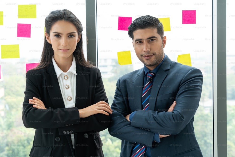 Successful business people standing together showing strong relationship of worker community. A team of businessman and businesswoman expressing a strong group teamwork at the modern office.