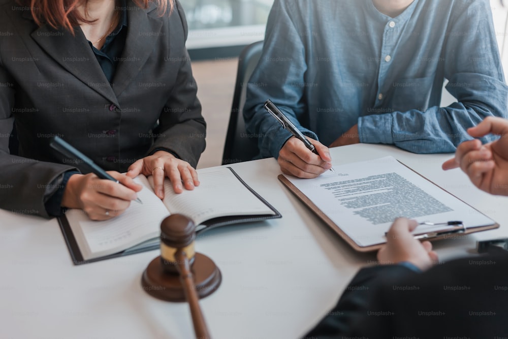 Businessman and lawyer sign the contract, the agreement in the document.