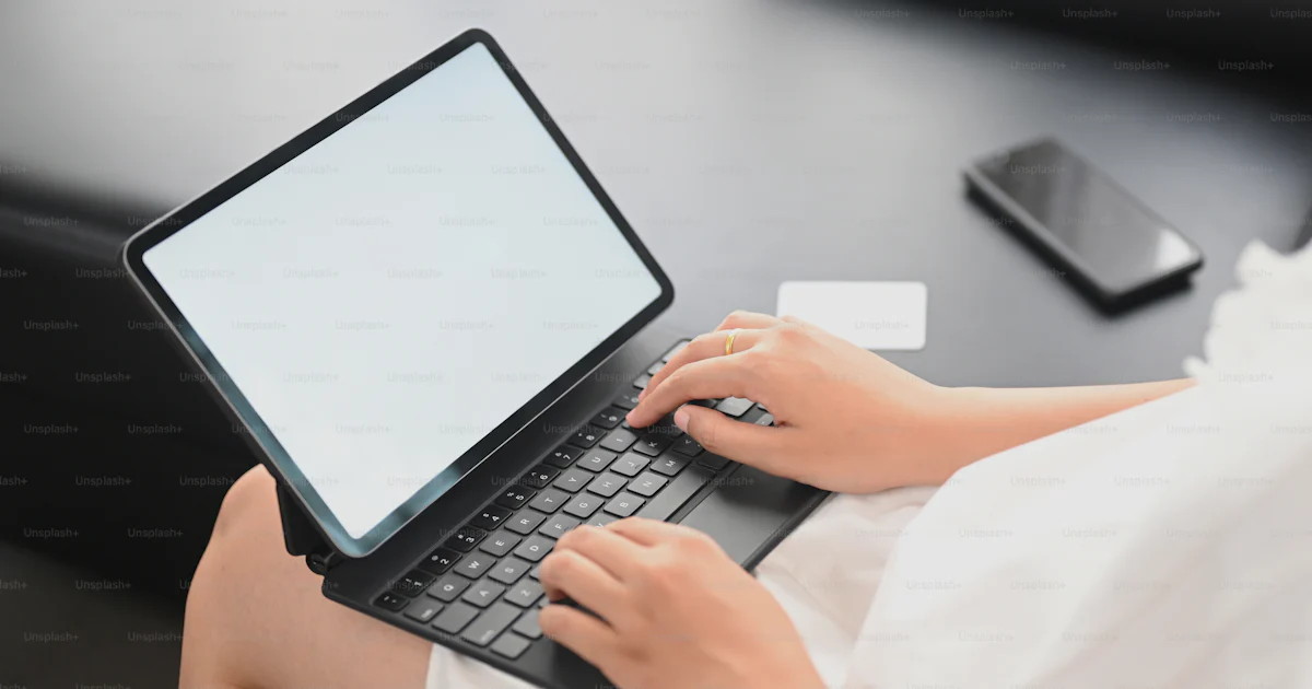 Unsplash Main Using Computer Cropped image hands are using a computer laptop at the black leather ...