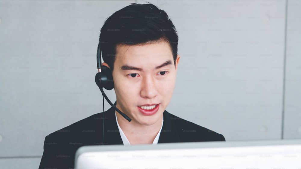 Business people wearing headset working in office to support remote customer or colleague. Call center, telemarketing, customer support agent provide service on telephone video conference call.