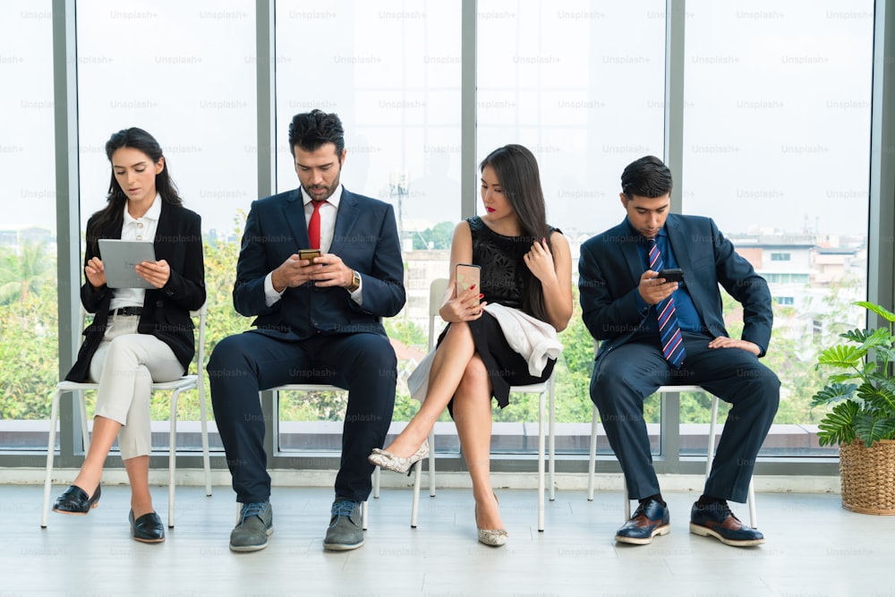 Job seekers and applicants waiting for interview on chairs in office. Job application and recruitment interview qualification concept.