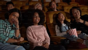 People audience watching movie in the movie theater cinema. Group recreation activity and entertainment concept.