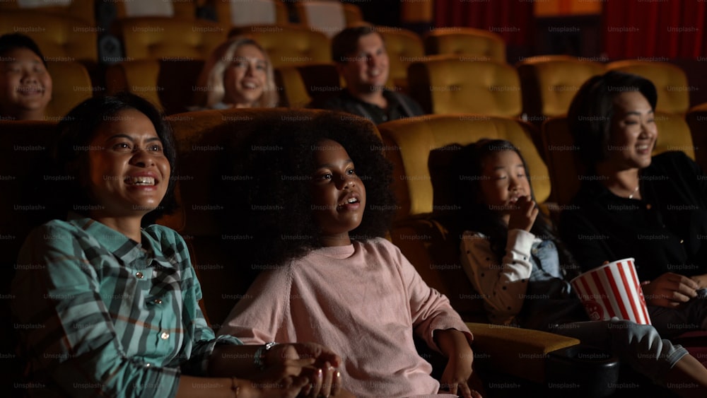 People audience watching movie in the movie theater cinema. Group recreation activity and entertainment concept.