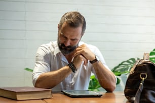 Portrait of Handsome beard guy reading news or working online on digital tablet