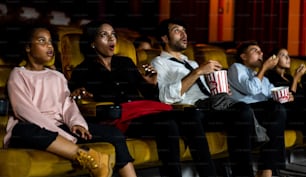 Shocked audience watching a horror movie in the cinema