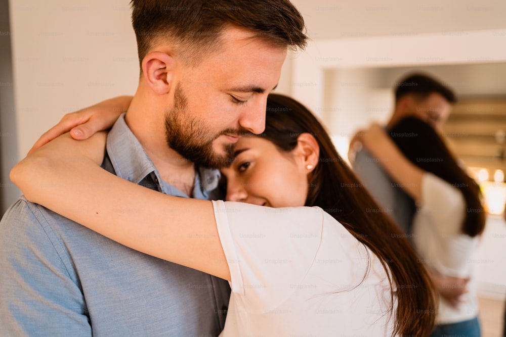 Portrait lovely couple hugging each other, smiling, enjoying time together