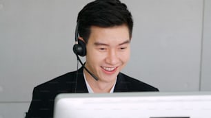 Business people wearing headset working in office to support remote customer or colleague. Call center, telemarketing, customer support agent provide service on telephone video conference call.