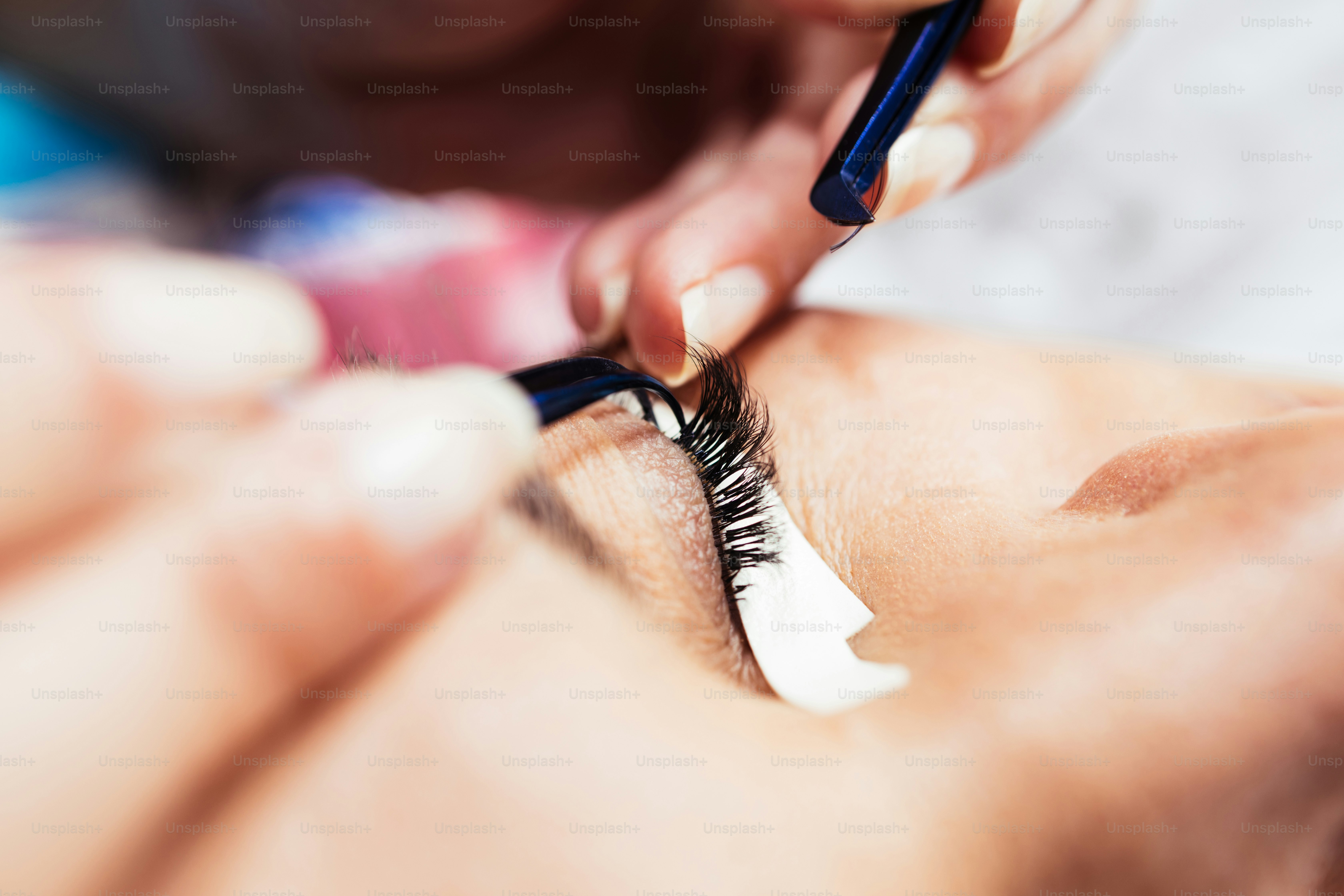 Beautiful middle age woman at eyelash extension procedure. Cosmetics and body care close up shot.