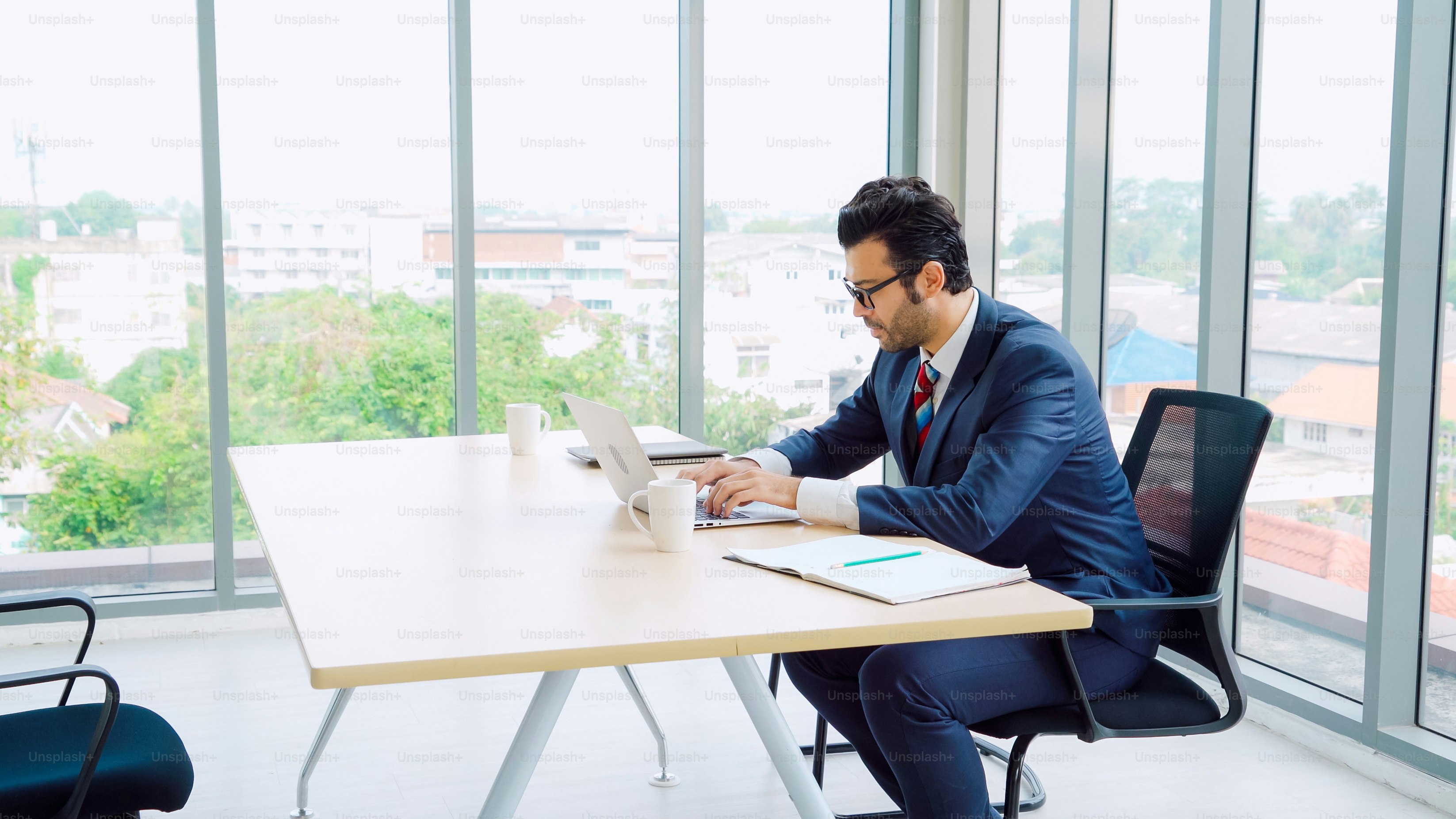 Business people working at table in modern office room while analyzing financial data report .