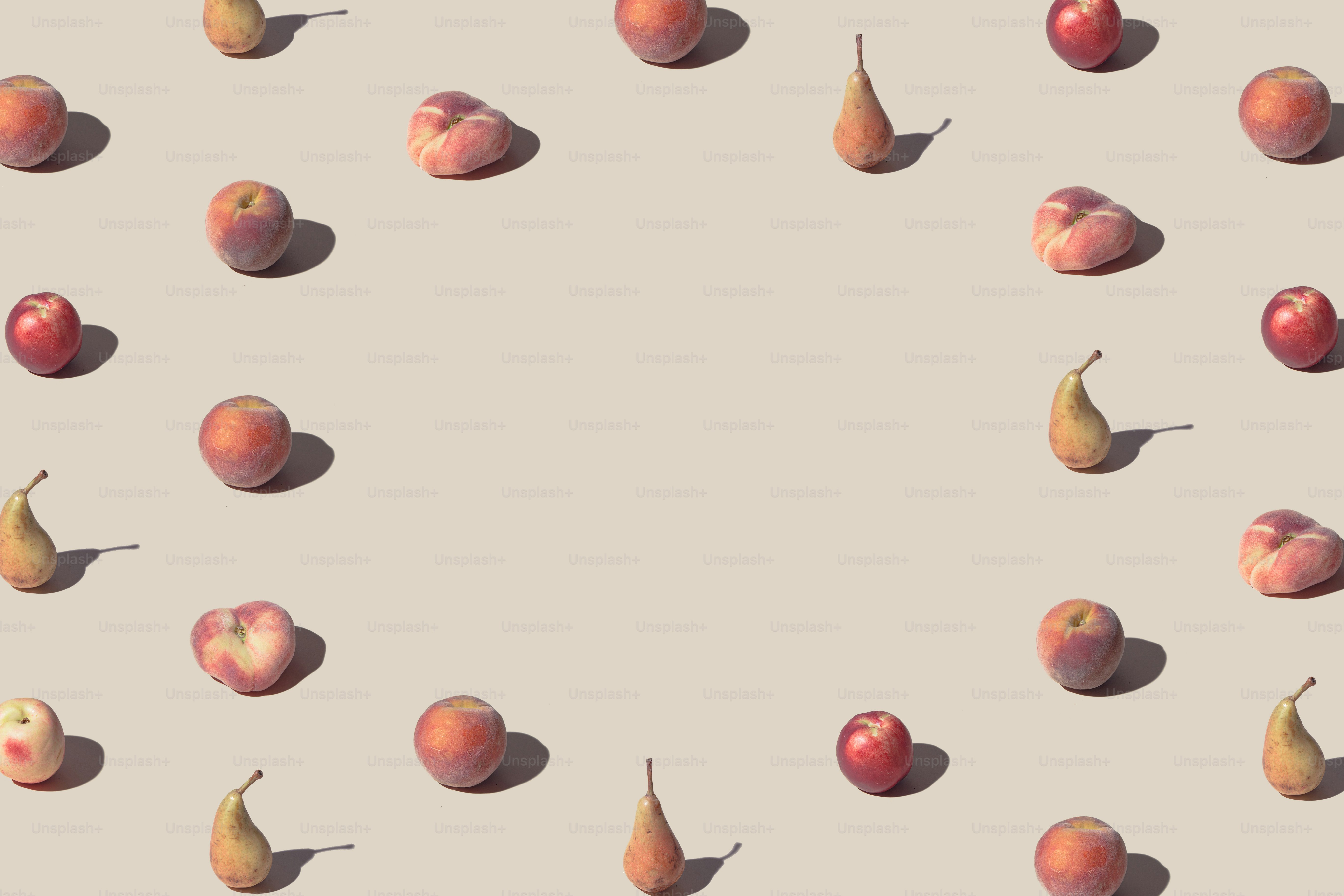 Crative pattern made with fresh peaches and pears against pastel beige background. Minimal summer fruit layout.