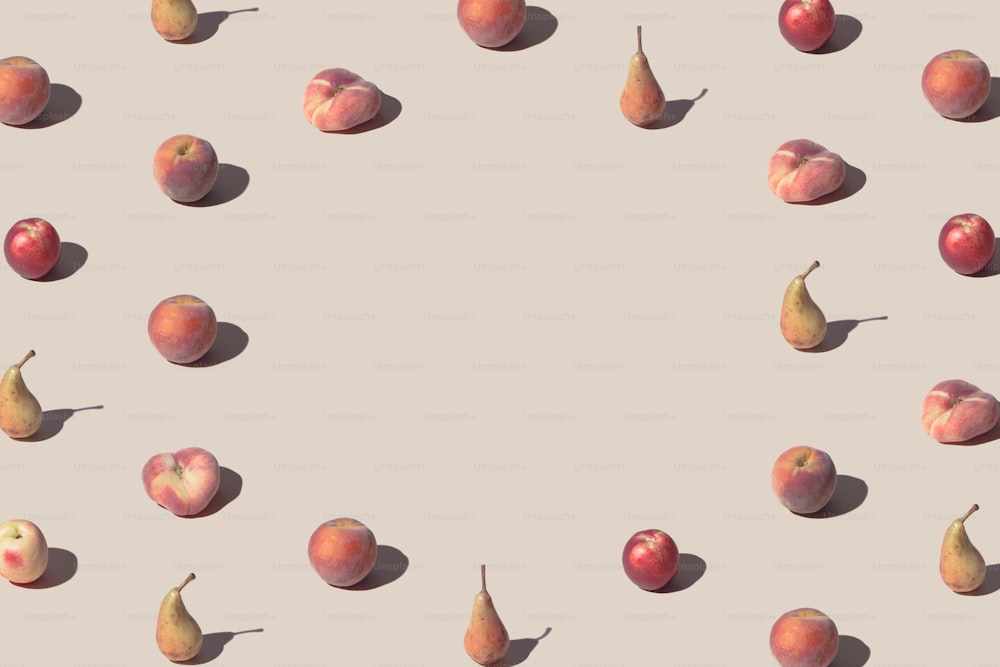 Crative pattern made with fresh peaches and pears against pastel beige background. Minimal summer fruit layout.