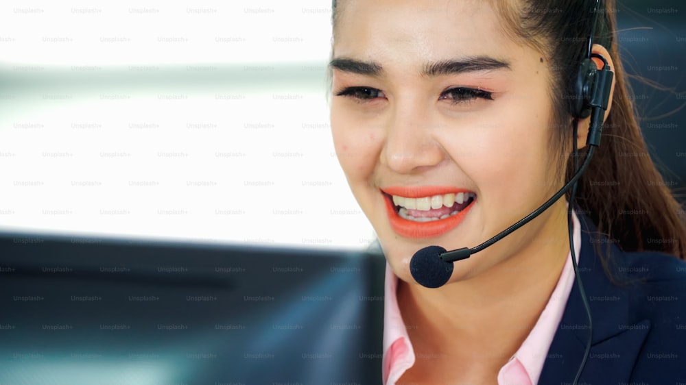 Business people wearing headset working in office to support remote customer or colleague. Call center, telemarketing, customer support agent provide service on telephone video conference call.