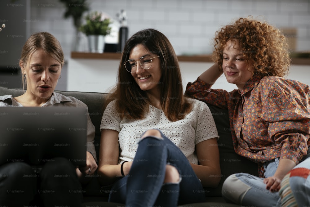 Happy businesswomen talking and laughing in office. Beautiful women drinking coffee in the office.