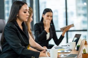 Group of Happy Asian businesswoman teamwork meeting with using laptop computer and digital tablet in modern office.