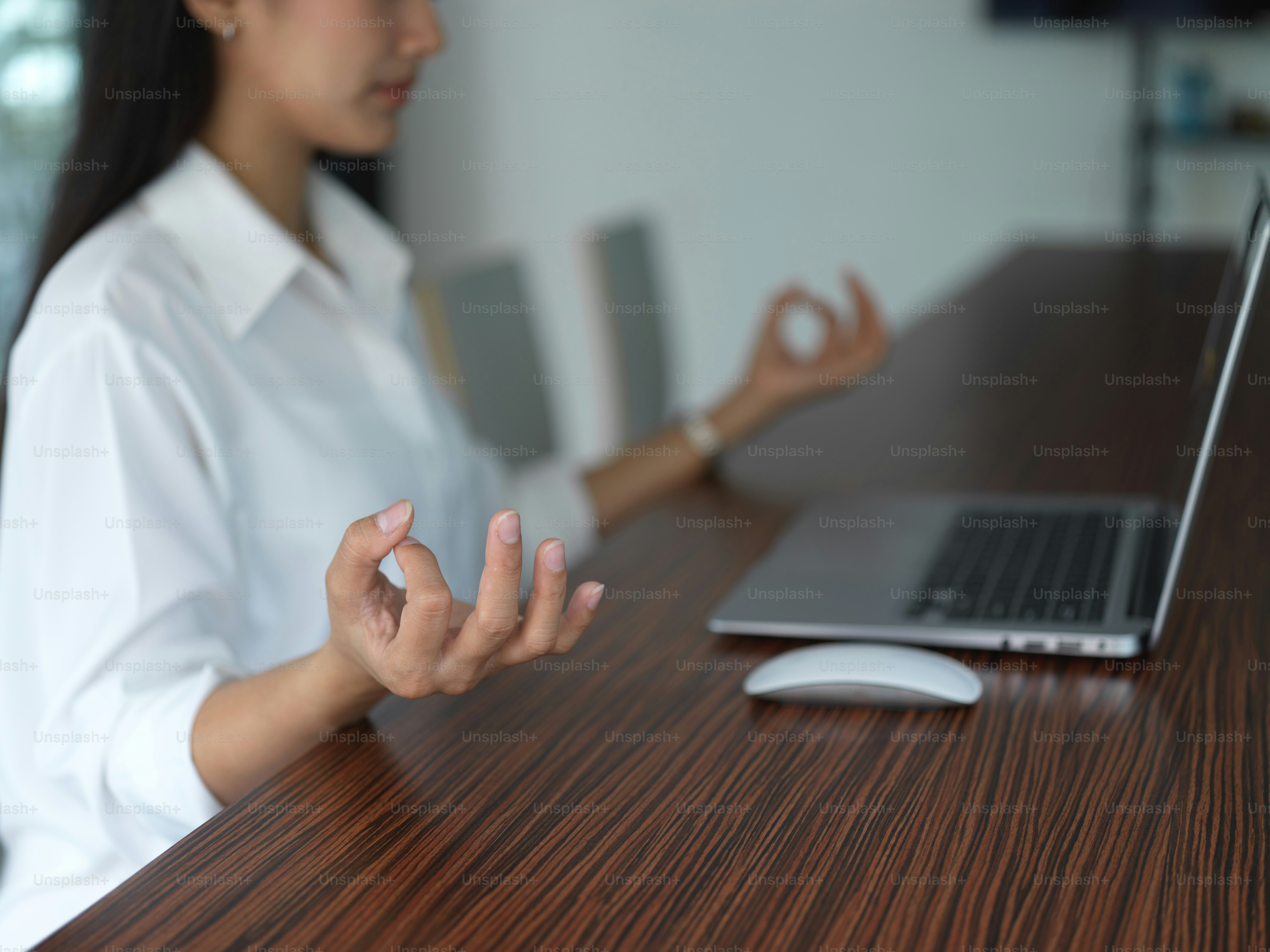 Cropped shot of young businesswoman mediating before working in her office room