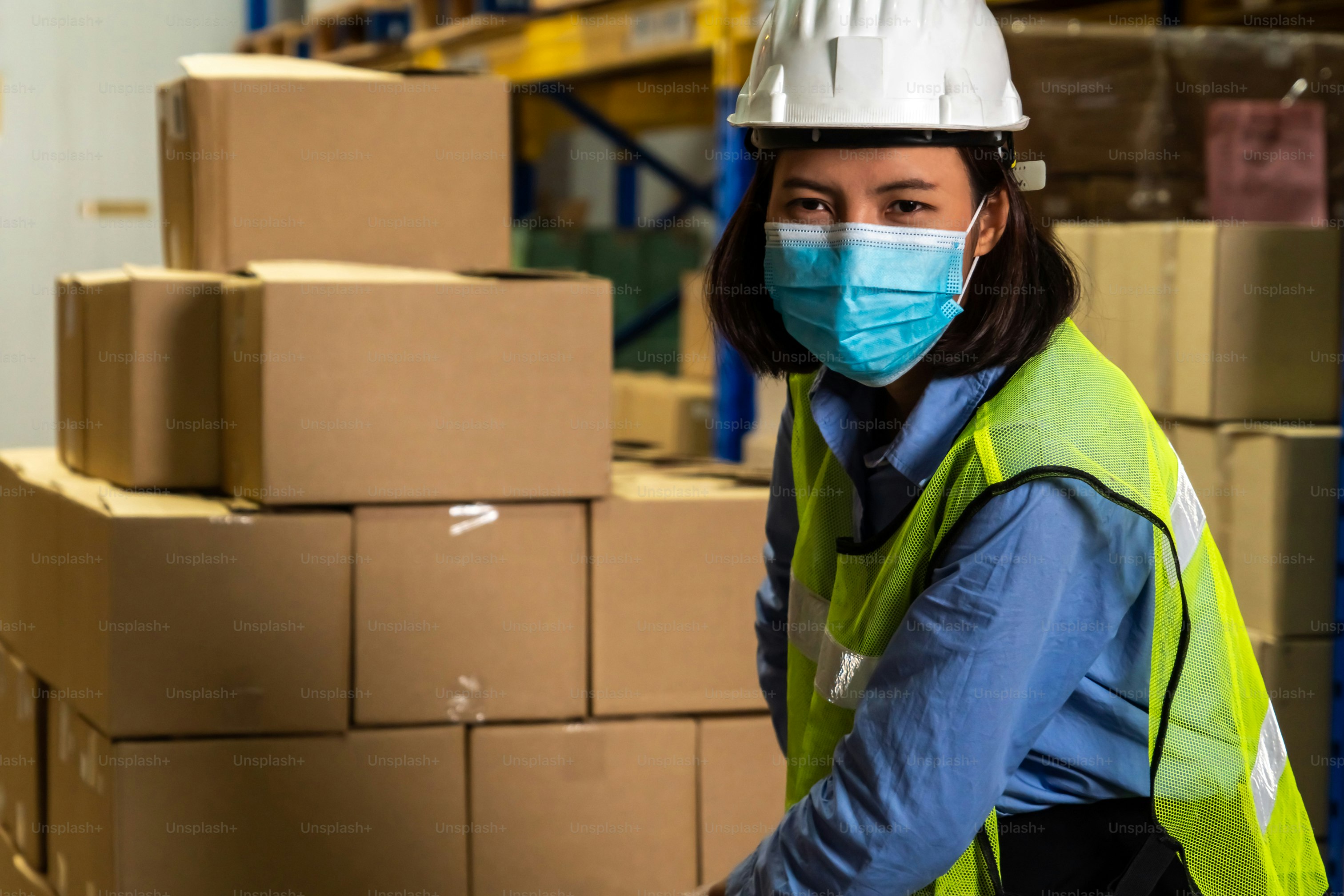 Factory industry worker working with face mask to prevent Covid-19 Coronavirus spreading during job reopening period .