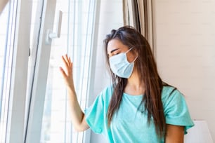 Young woman in medical mask stay isolation at home for self quarantine. Concept home quarantine, prevention COVID-19, Coronavirus outbreak situation