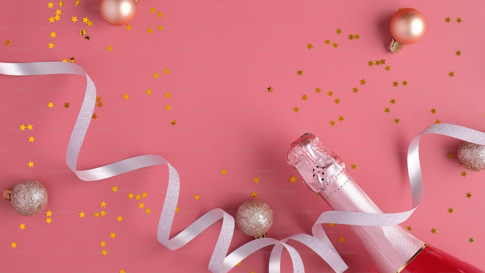 Bottiglia di champagne con stelle di coriandoli e streamer per feste su sfondo rosa. Concetto di festa di Natale o di compleanno. Posa piatta, vista dall'alto
