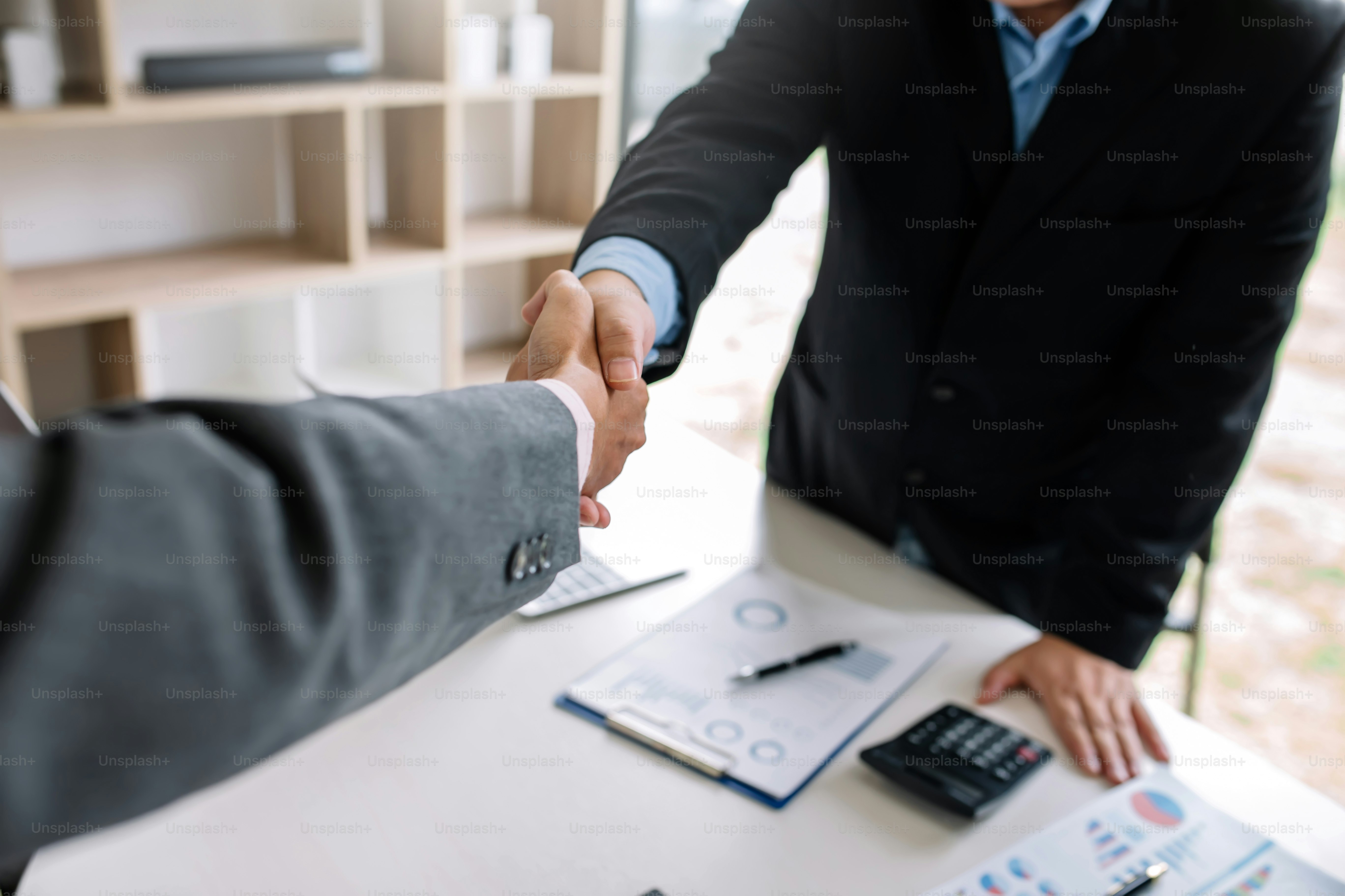 Businessman shaking hands agreement confirmed in the investment business.
