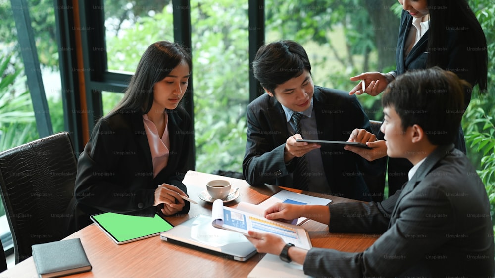 Group of business persons having different age in creative business discussing work in modern office