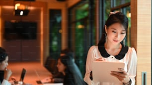 Portrait of bussiness woman writing for planning working schedule at modern office.