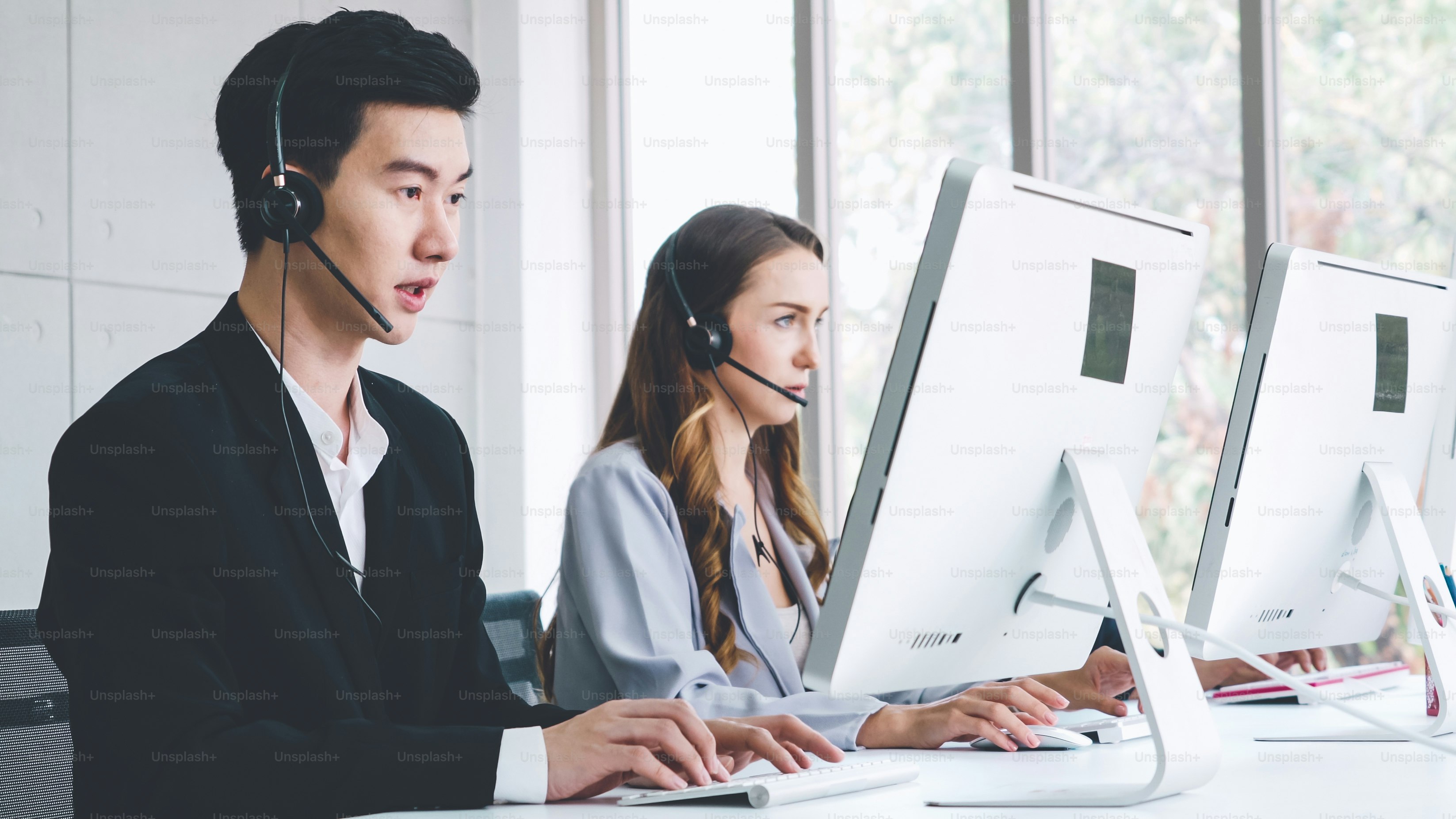Business people wearing headset working in office to support remote customer or colleague. Call center, telemarketing, customer support agent provide service on telephone video conference call.