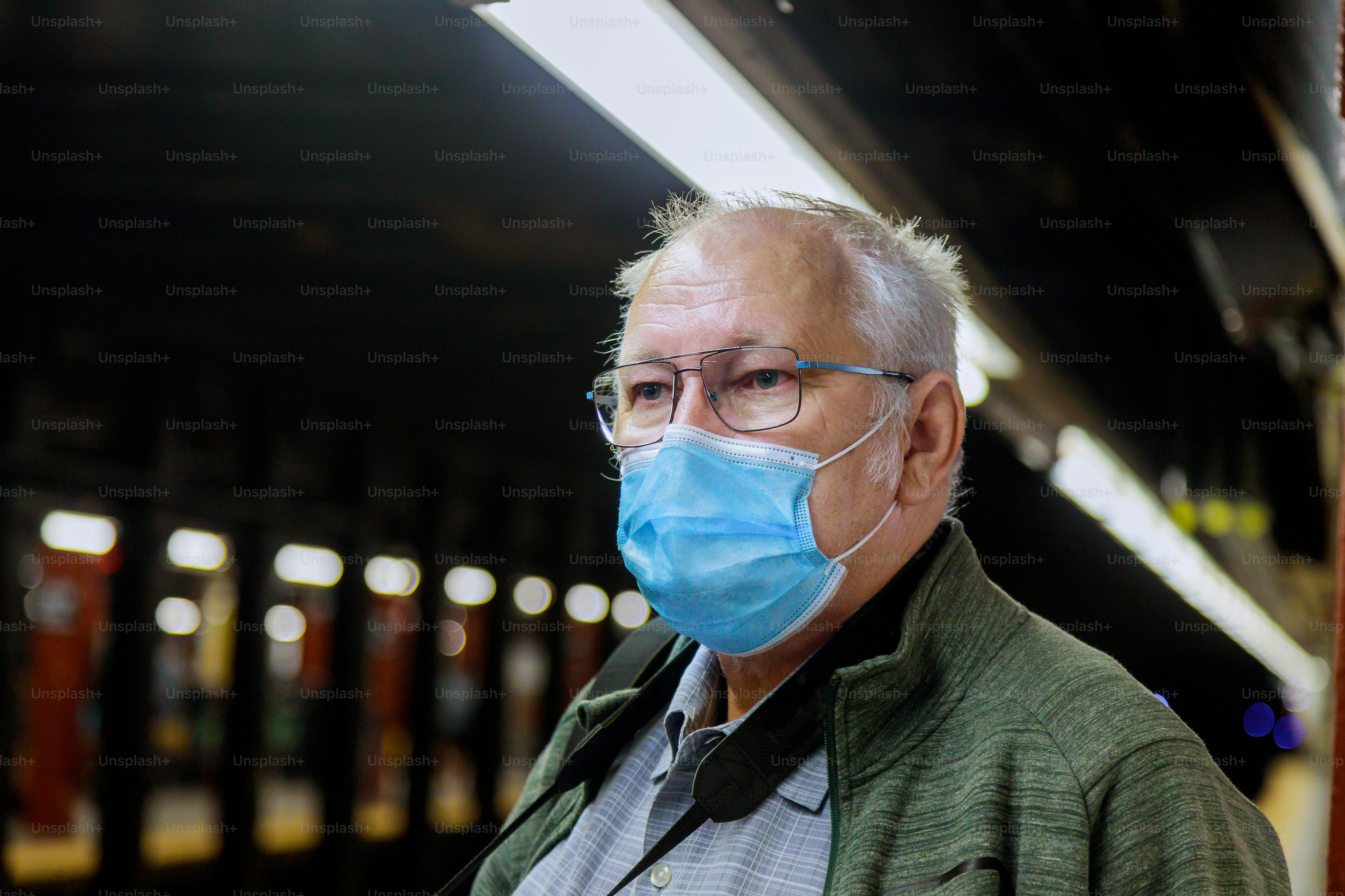 Safety in a public place while epidemic mature man wearing disposable medical face mask of the subway in New York during coronavirus outbreak of covid-19.