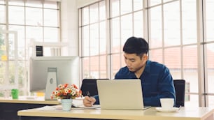 Business people working at table in modern office room while analyzing financial data report .