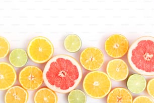 Different citrus and juicy slices on a light background top view. Place to insert text.