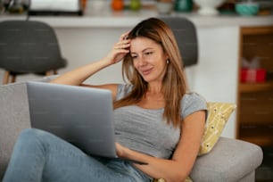 Young woman having video call. Beautiful woman enjoying at home.