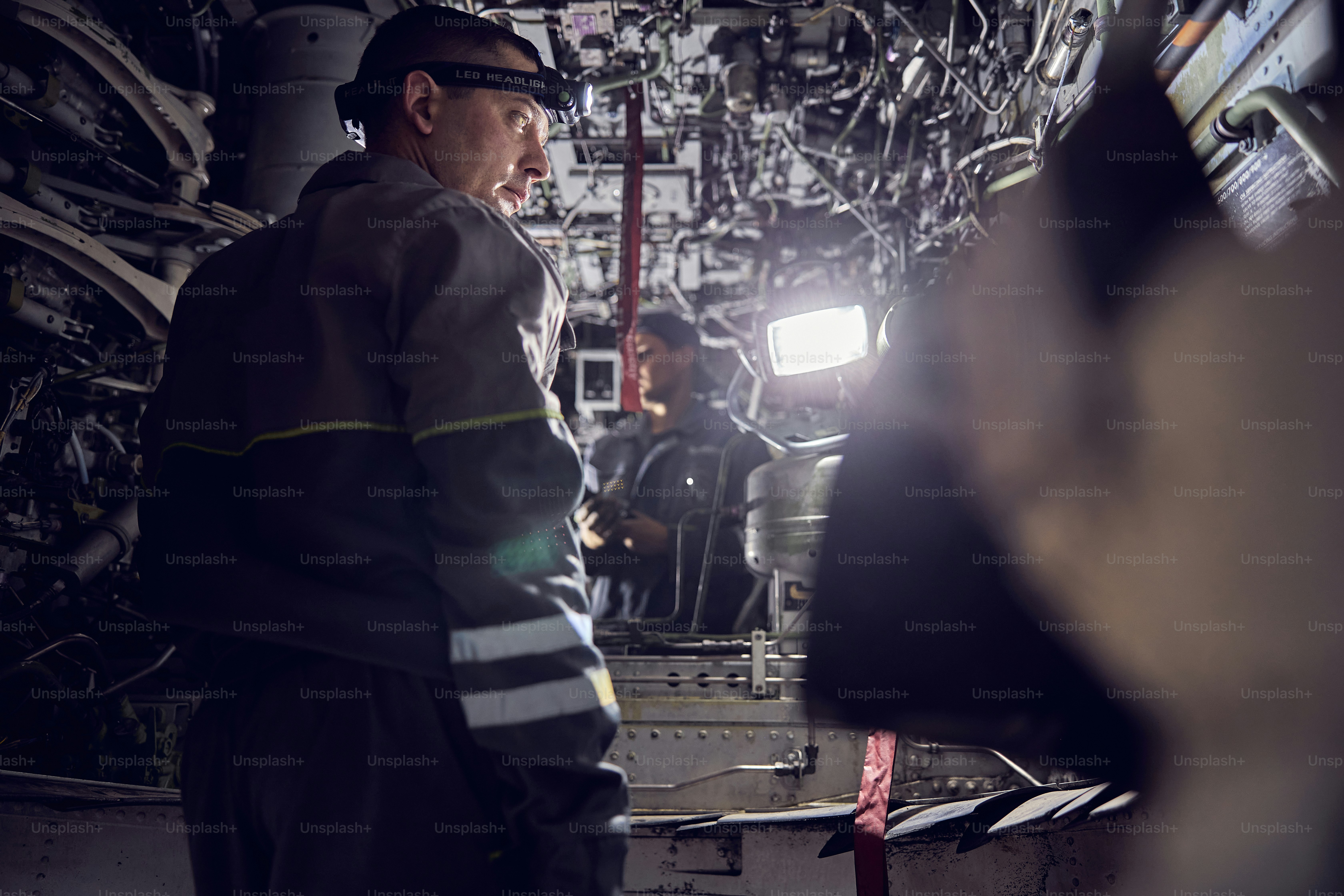 Back view portrait of aviation mechanic working on the modernization ...